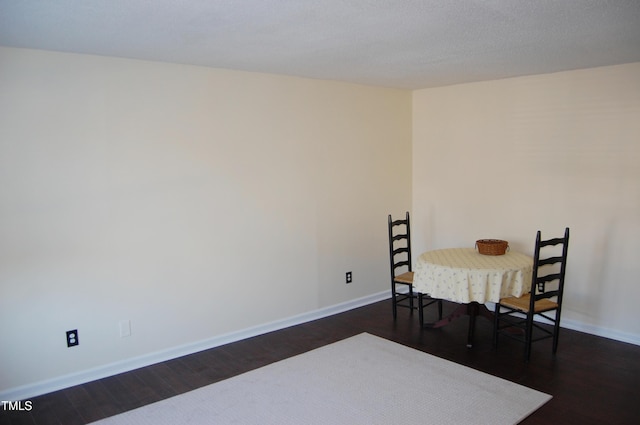 dining area with dark hardwood / wood-style floors