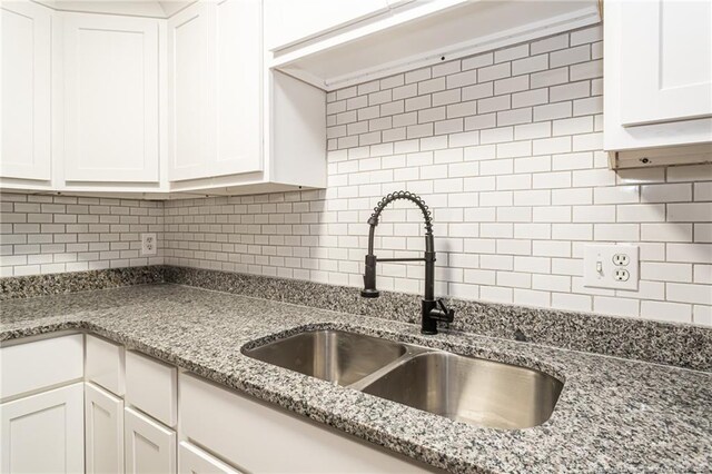 5193 Southport Dr, Fayetteville, NC 28311 - kitchen featuring backsplash, light stone counters, sink, and white cabinets