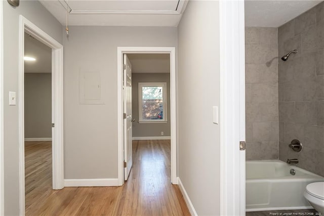 5193 Southport Dr, Fayetteville, NC 28311 - bathroom featuring hardwood / wood-style flooring, toilet, and tiled shower / bath