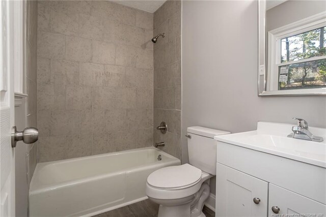 5193 Southport Dr, Fayetteville, NC 28311 - full bathroom with vanity, tiled shower / bath, wood-type flooring, and toilet