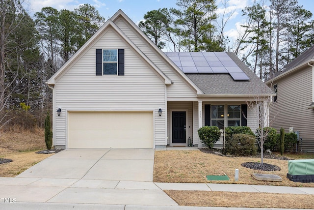 view of front of house featuring a garage and solar panels