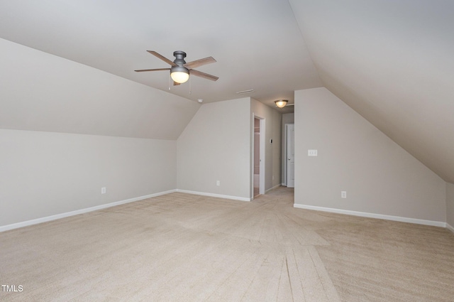 additional living space with ceiling fan, vaulted ceiling, and light carpet