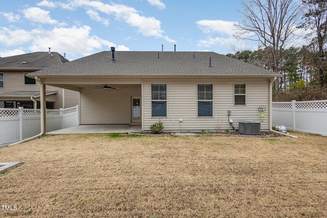 rear view of property featuring central AC, ceiling fan, a patio, and a lawn