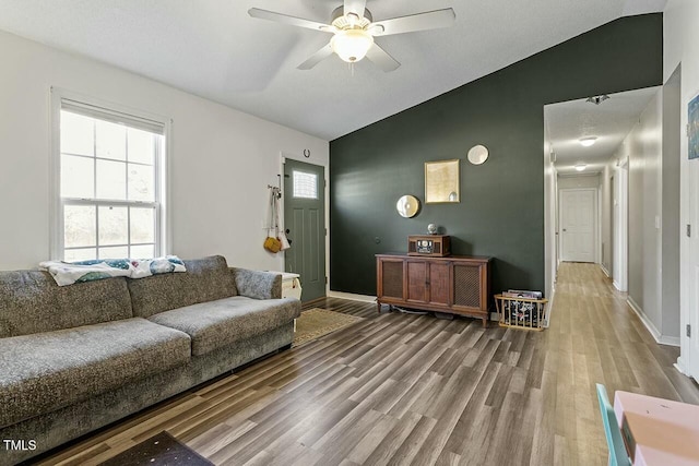 living room with ceiling fan, hardwood / wood-style floors, and lofted ceiling