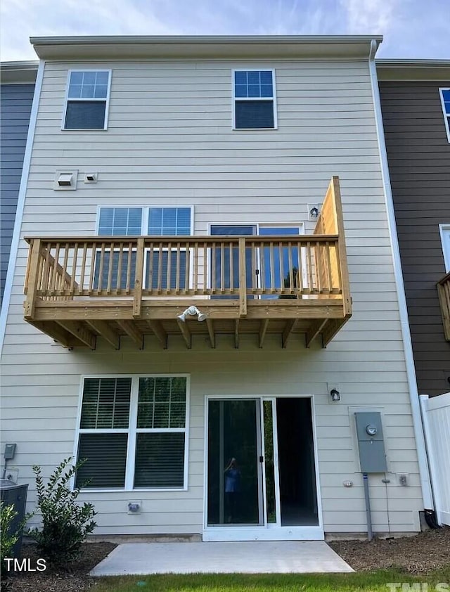 rear view of property featuring a balcony