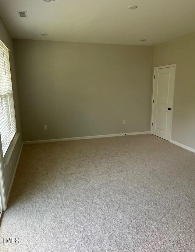 spare room with light carpet