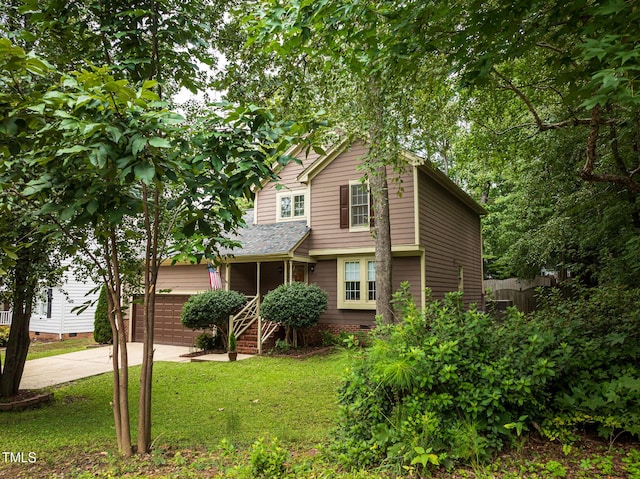 view of front property with a garage and a front yard