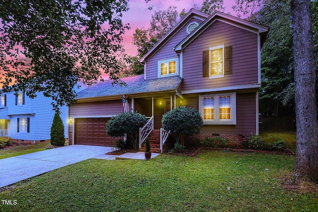 view of property featuring a garage and a yard