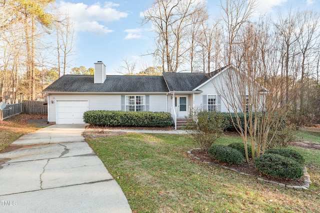 view of front of house featuring a garage and a front lawn