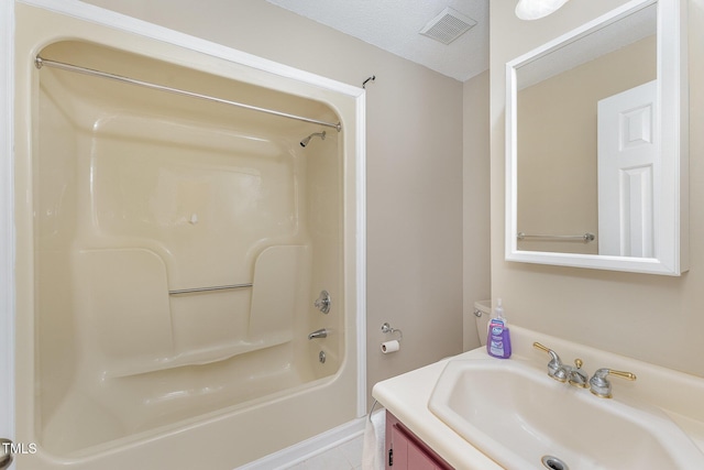 bathroom with vanity, a textured ceiling, shower / bathtub combination, and tile patterned flooring