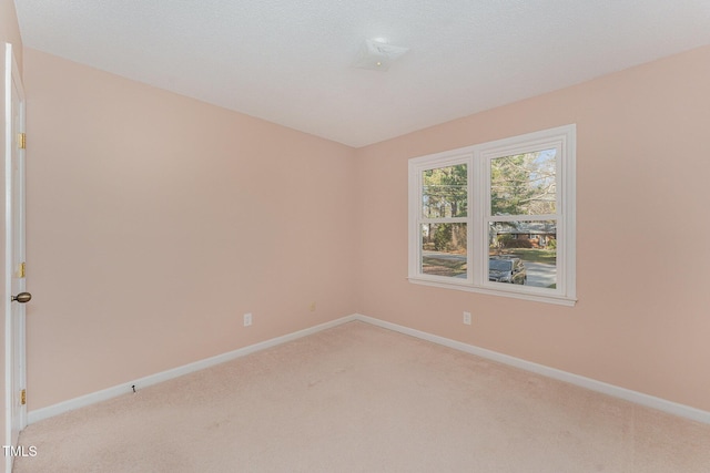 empty room featuring light colored carpet