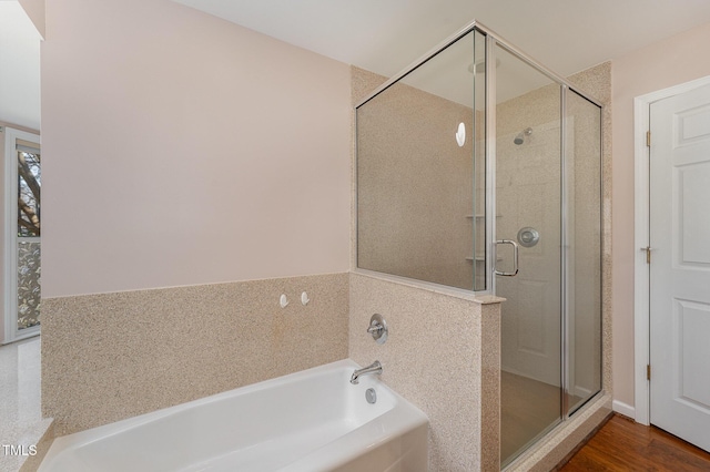 bathroom with hardwood / wood-style flooring and independent shower and bath