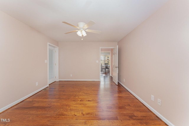 spare room with hardwood / wood-style flooring and ceiling fan