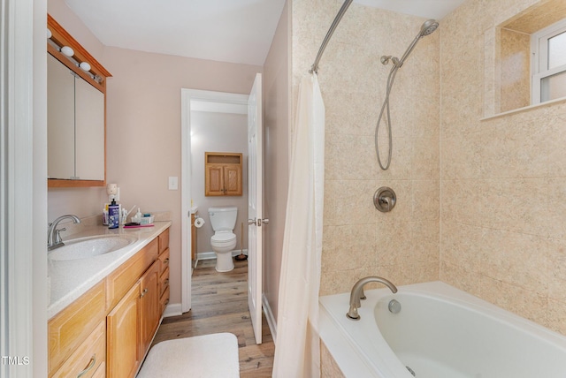 full bathroom with shower / bath combination with curtain, vanity, hardwood / wood-style flooring, and toilet