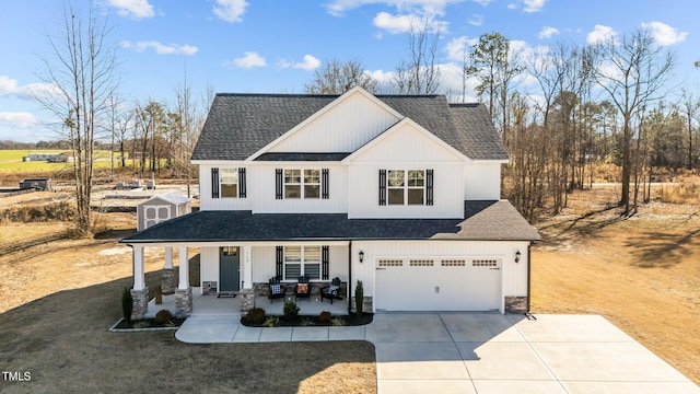 view of front of property with a garage, covered porch, and a storage unit