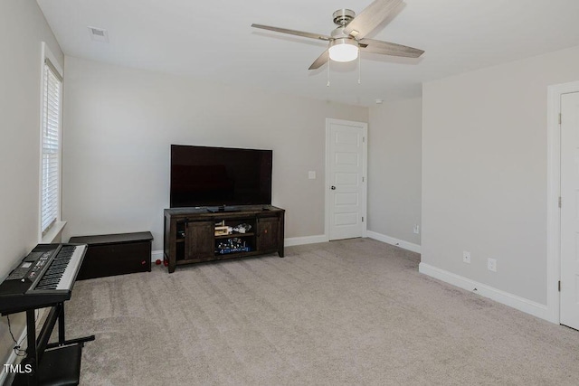 unfurnished living room with ceiling fan and carpet floors