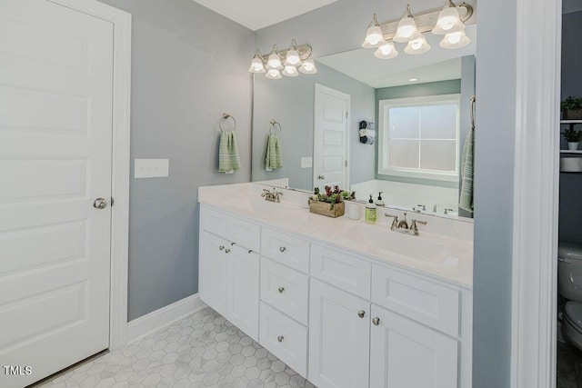 bathroom featuring tile patterned flooring, vanity, and toilet