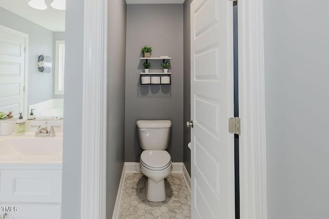 bathroom featuring tile patterned flooring, vanity, and toilet