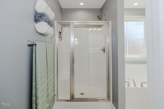 bathroom featuring a shower with door