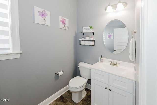 bathroom featuring hardwood / wood-style flooring, vanity, and toilet