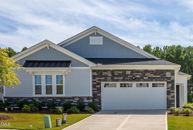 craftsman house featuring a front yard and a garage