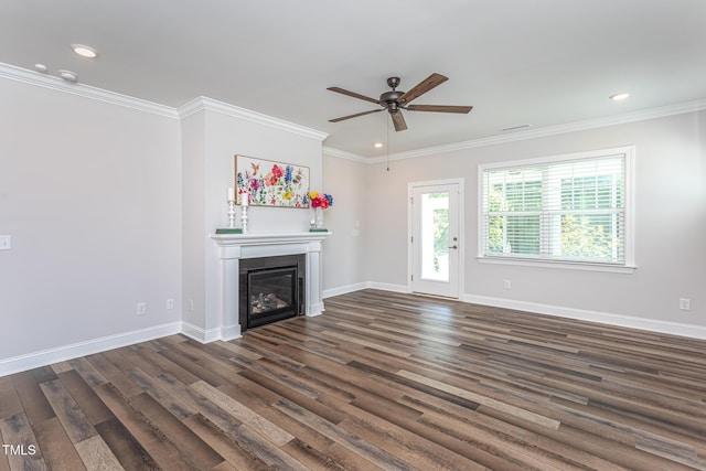 unfurnished living room featuring ceiling fan, crown molding, and dark wood-type flooring