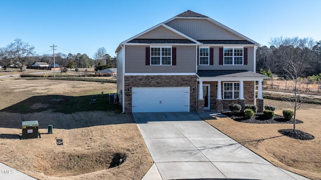 view of front of house with a garage and central AC