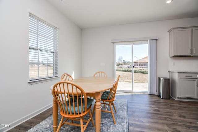 dining space with dark hardwood / wood-style flooring