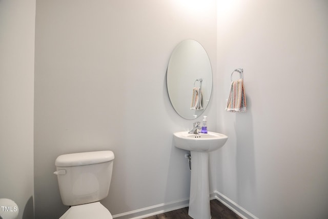 bathroom with wood-type flooring and toilet