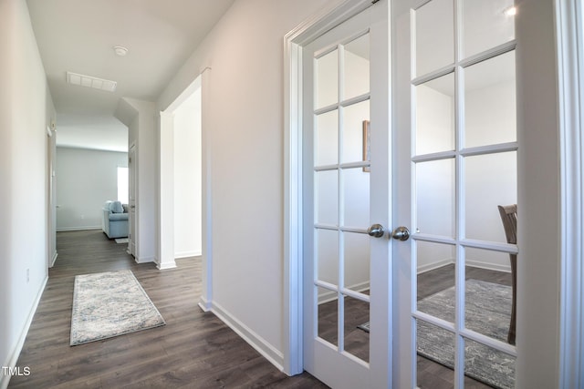 hallway featuring dark wood-type flooring and french doors