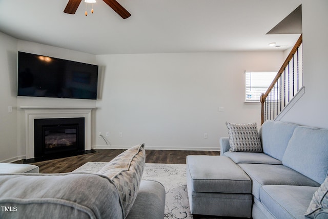 living room with ceiling fan and dark hardwood / wood-style flooring