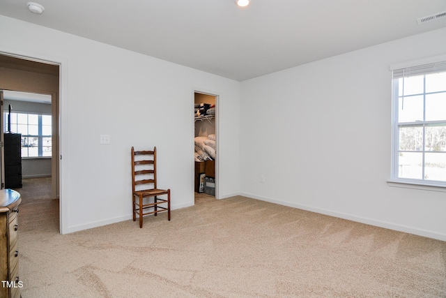 carpeted empty room featuring plenty of natural light