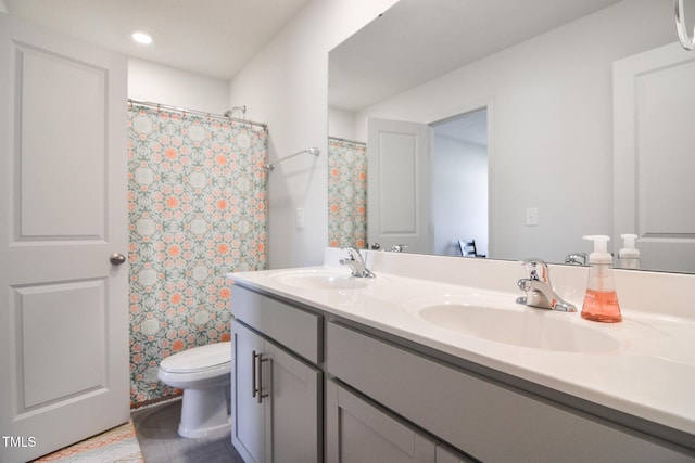 bathroom with vanity, curtained shower, and toilet