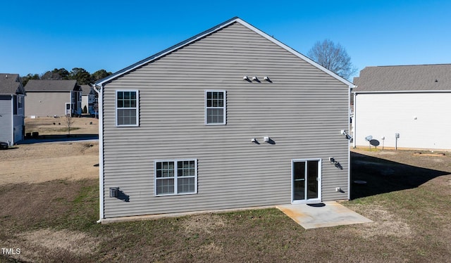 back of house with a lawn