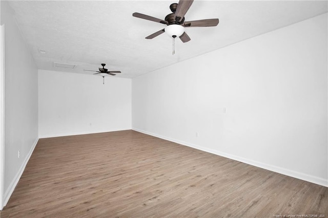 empty room featuring hardwood / wood-style flooring and ceiling fan