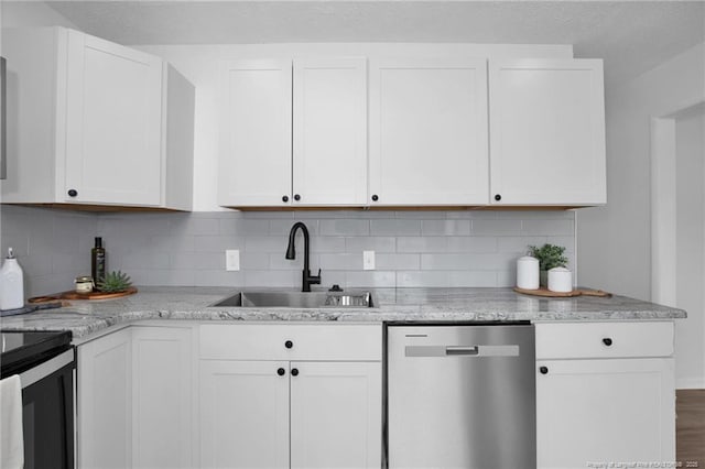 kitchen with dishwasher, backsplash, white cabinetry, and sink