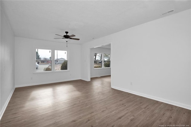 empty room featuring dark hardwood / wood-style floors and ceiling fan