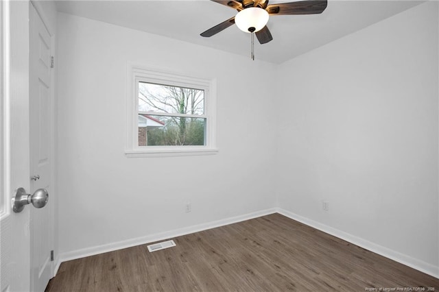 empty room with ceiling fan and dark hardwood / wood-style floors