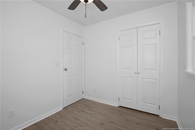 unfurnished bedroom featuring light wood-type flooring, a closet, and ceiling fan