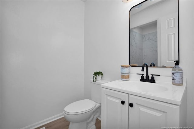 bathroom with vanity, wood-type flooring, and toilet