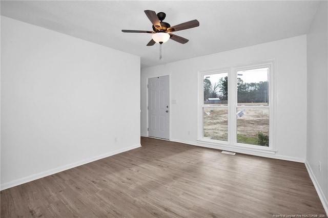 unfurnished room with hardwood / wood-style floors and ceiling fan