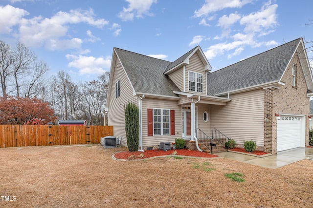 view of front of property featuring a garage and central AC unit