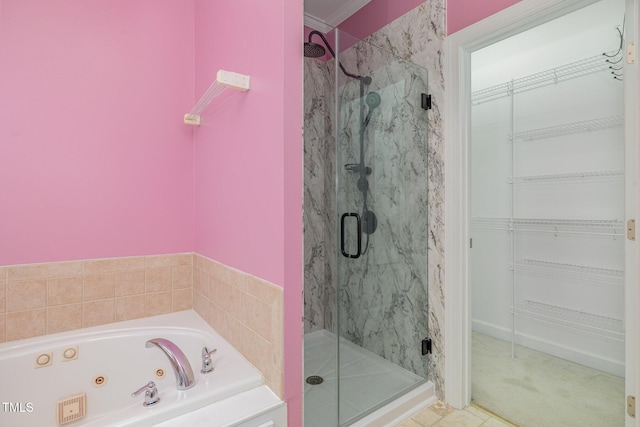 bathroom with independent shower and bath and tile patterned flooring