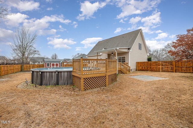 rear view of house featuring a pool side deck