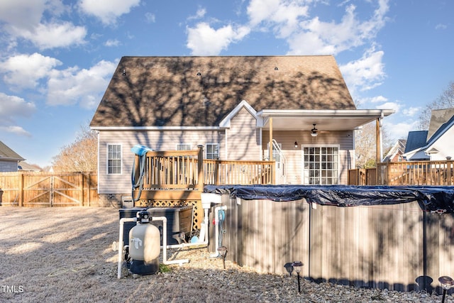 rear view of house with a pool side deck