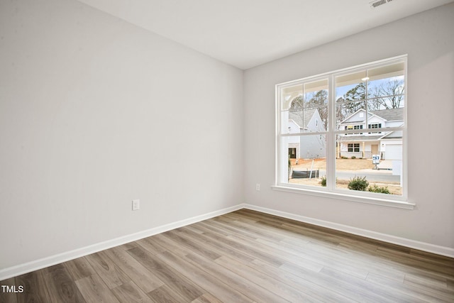 empty room with light hardwood / wood-style flooring