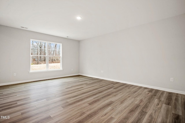 spare room featuring wood-type flooring