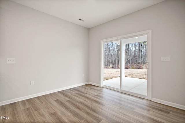 unfurnished room with light hardwood / wood-style floors