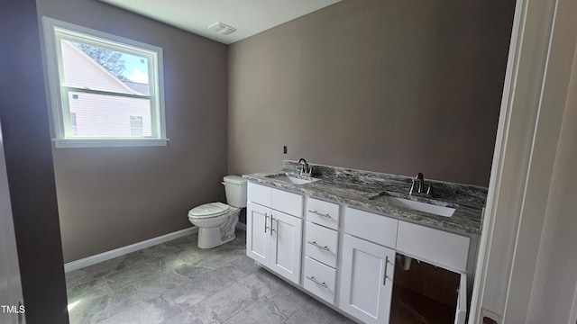 121 Tanglewood Dr Unit 8-J, Louisburg, NC 27549 - bathroom featuring baseboards, toilet, and double vanity