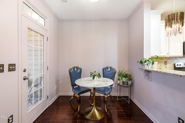 dining room with dark hardwood / wood-style flooring and ornamental molding